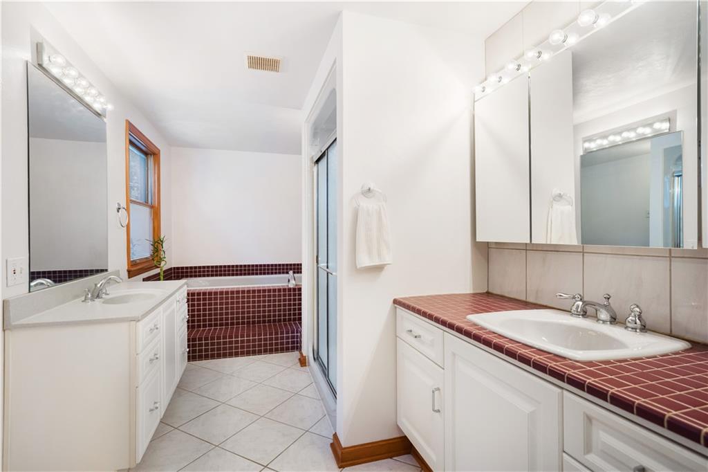 111 Siebert Road Pittsburgh, PA 15237 - Photo 17 of 25 a bathroom with a granite countertop sink a mirror and a