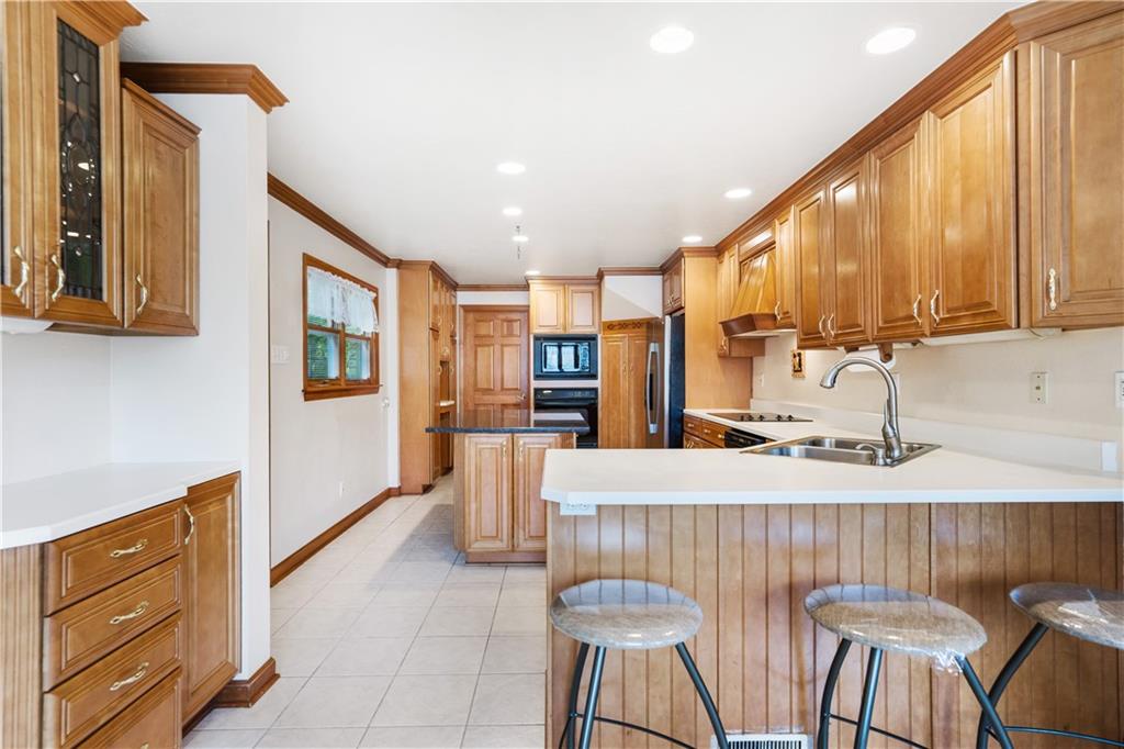 111 Siebert Road Pittsburgh, PA 15237 - Photo 9 of 25 a kitchen with stainless steel appliances kitchen island granite countertop a table and chairs