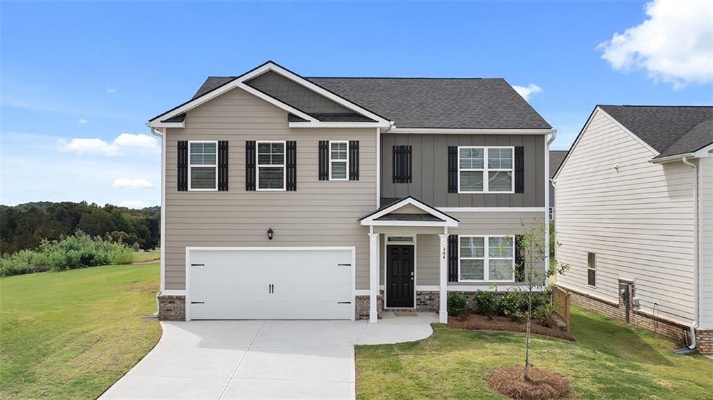212 Cattle Drive Perry, GA 31069 - Photo 1 of 40 a front view of a house with garden