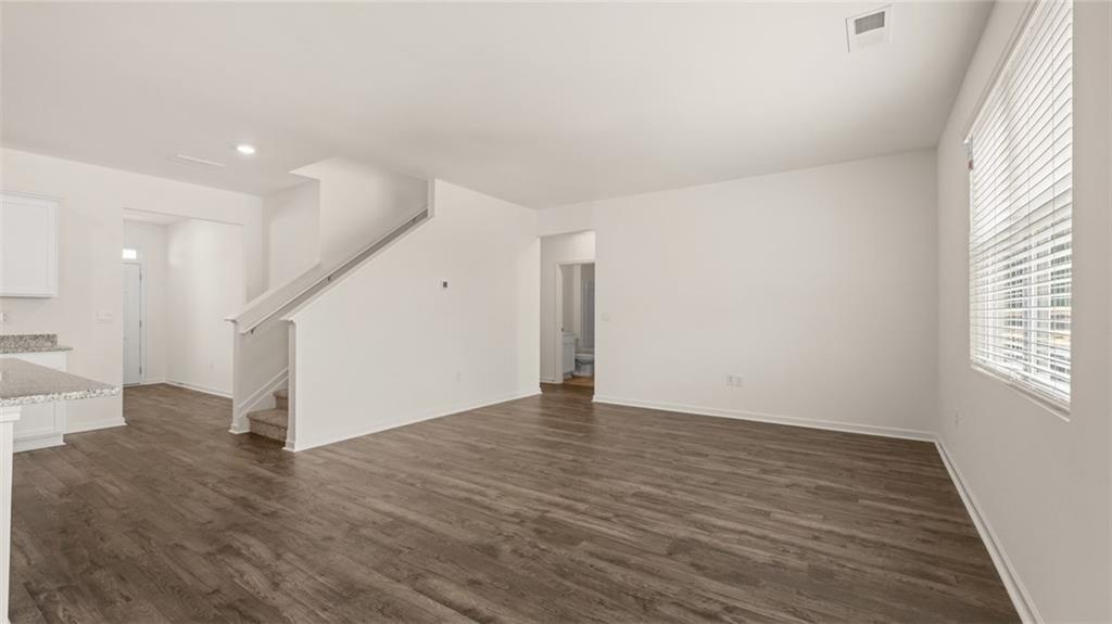 212 Cattle Drive Perry, GA 31069 - Photo 12 of 40 a view of an empty room with wooden floor and a window
