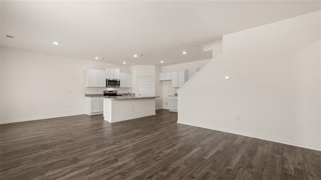 212 Cattle Drive Perry, GA 31069 - Photo 14 of 40 a view of kitchen with kitchen island wooden floors and stainless steel appliances