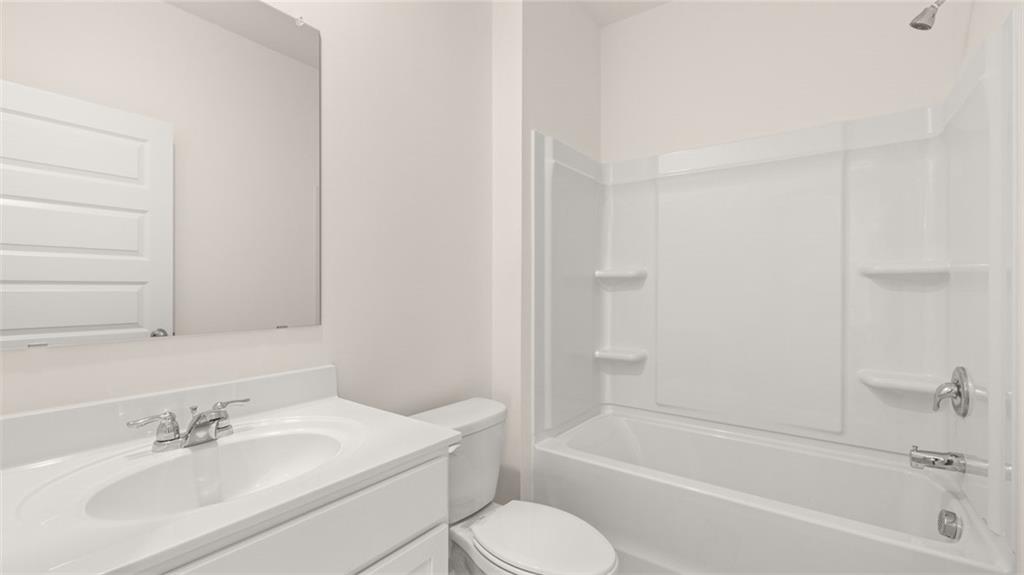 212 Cattle Drive Perry, GA 31069 - Photo 17 of 40 a bathroom with a bathtub shower sink vanity and toilet