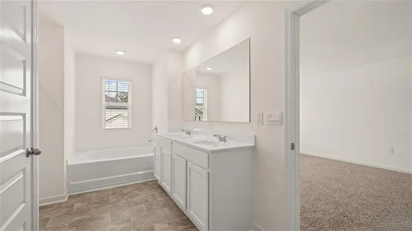 a bathroom with a bathtub and a sink