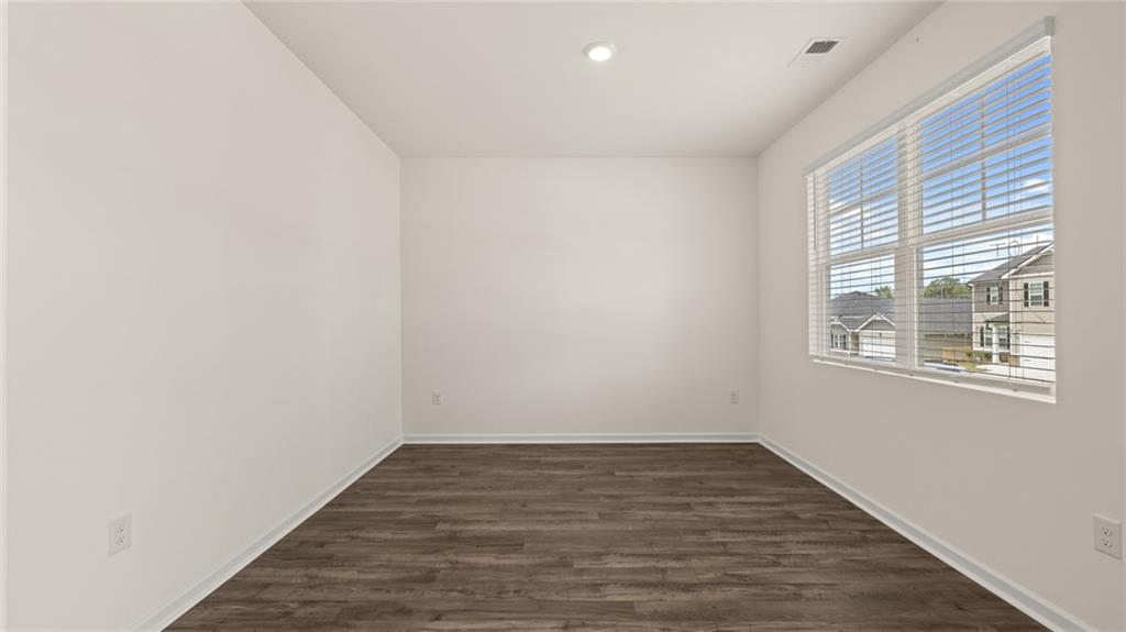 212 Cattle Drive Perry, GA 31069 - Photo 3 of 40 a view of an empty room with wooden floor and a window