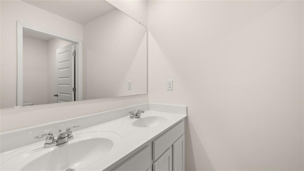 212 Cattle Drive Perry, GA 31069 - Photo 38 of 40 a bathroom with a sink and a mirror