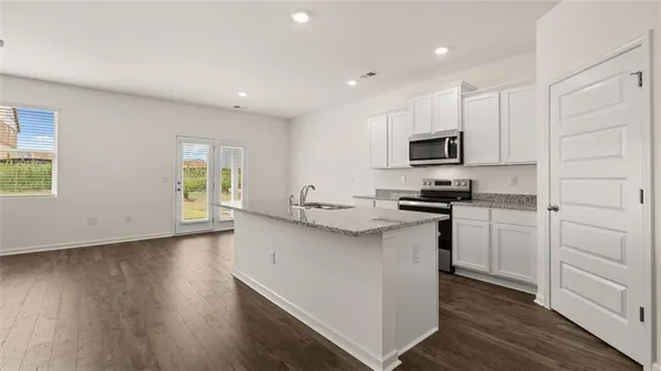 a kitchen with a sink a window and stainless steel appliances