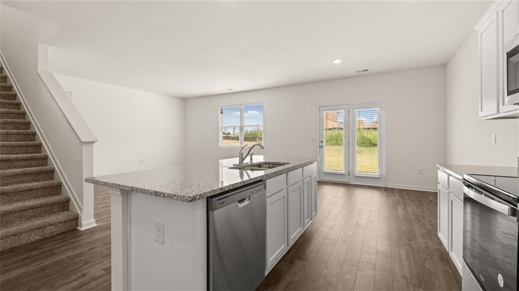 212 Cattle Drive Perry, GA 31069 - Photo 6 of 40 a kitchen with granite countertop a sink and a stove top oven