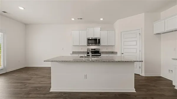 a kitchen with stainless steel appliances a sink stove and cabinets