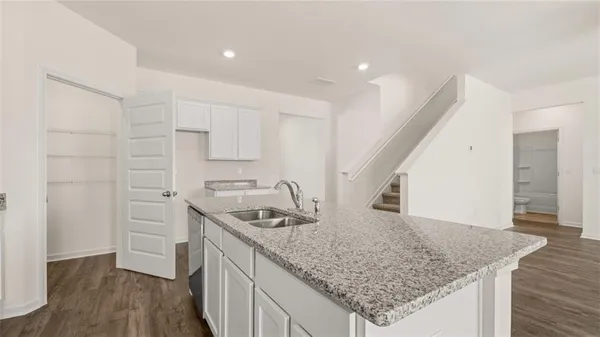 a kitchen with stainless steel appliances granite countertop a sink stove and cabinets