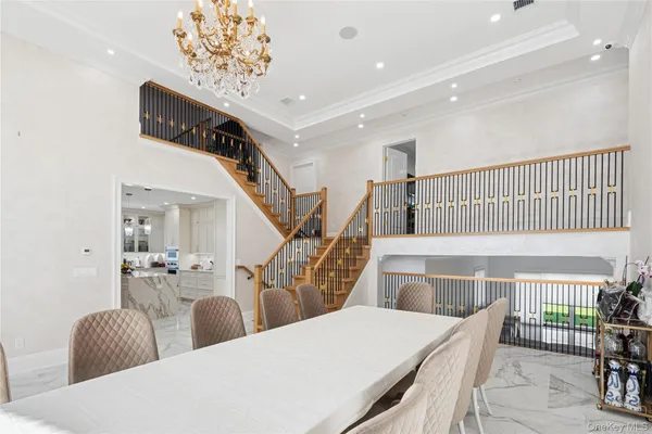 a living room with chairs and a wooden floor
