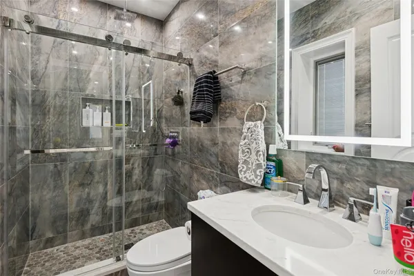 a bathroom with a sink toilet and shower