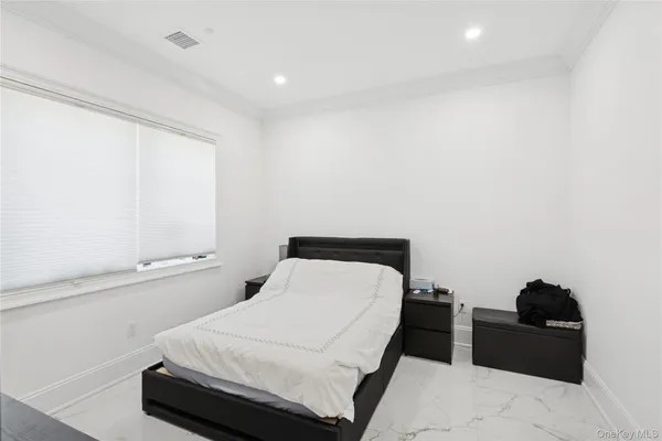 a bedroom with a bed and window