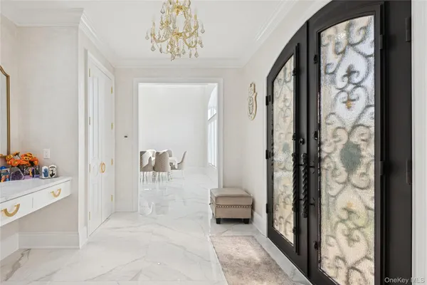 a view of a hallway with bathroom and shower