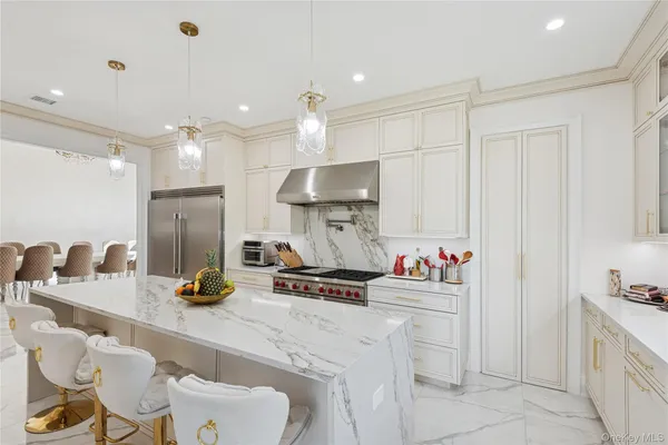 a kitchen with a sink a stove and chairs