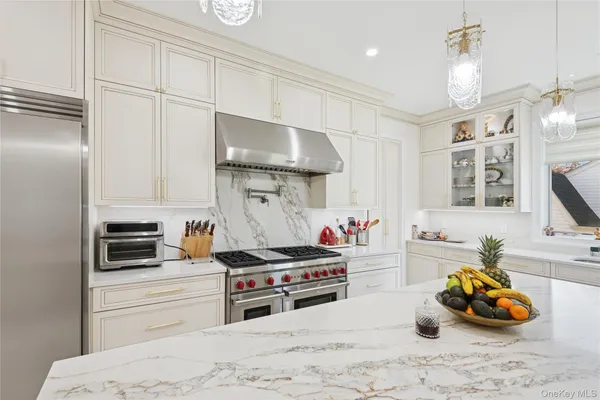 a kitchen with a stove a sink and a refrigerator