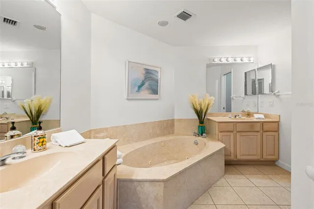 a bathroom with a tub sink and a mirror