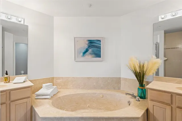 a spacious bedroom with a bed and a ceiling fan