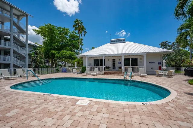 a view of a house with swimming pool and sitting area