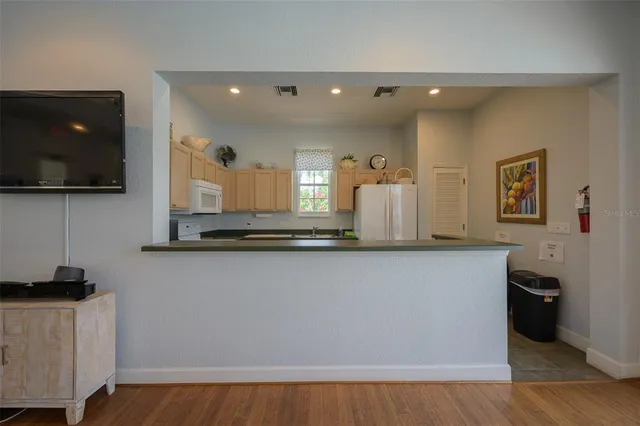 a kitchen with stainless steel appliances granite countertop wooden floors and sink