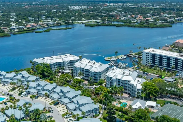 an aerial view of a house with a garden and lake view