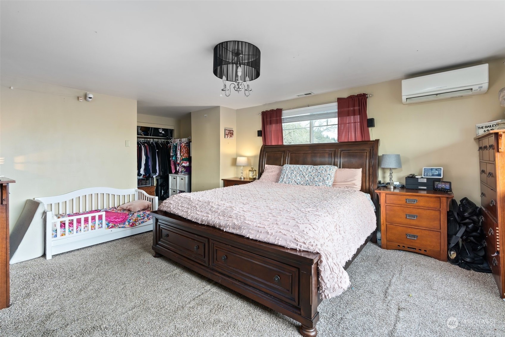 73 East Main Street Chehalis, WA 98532 - Photo 15 of 35 a bedroom with a bed and a chandelier