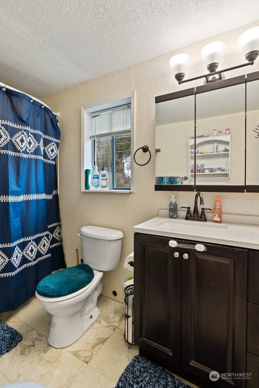 73 East Main Street Chehalis, WA 98532 - Photo 20 of 35 a bathroom with a toilet sink and mirror