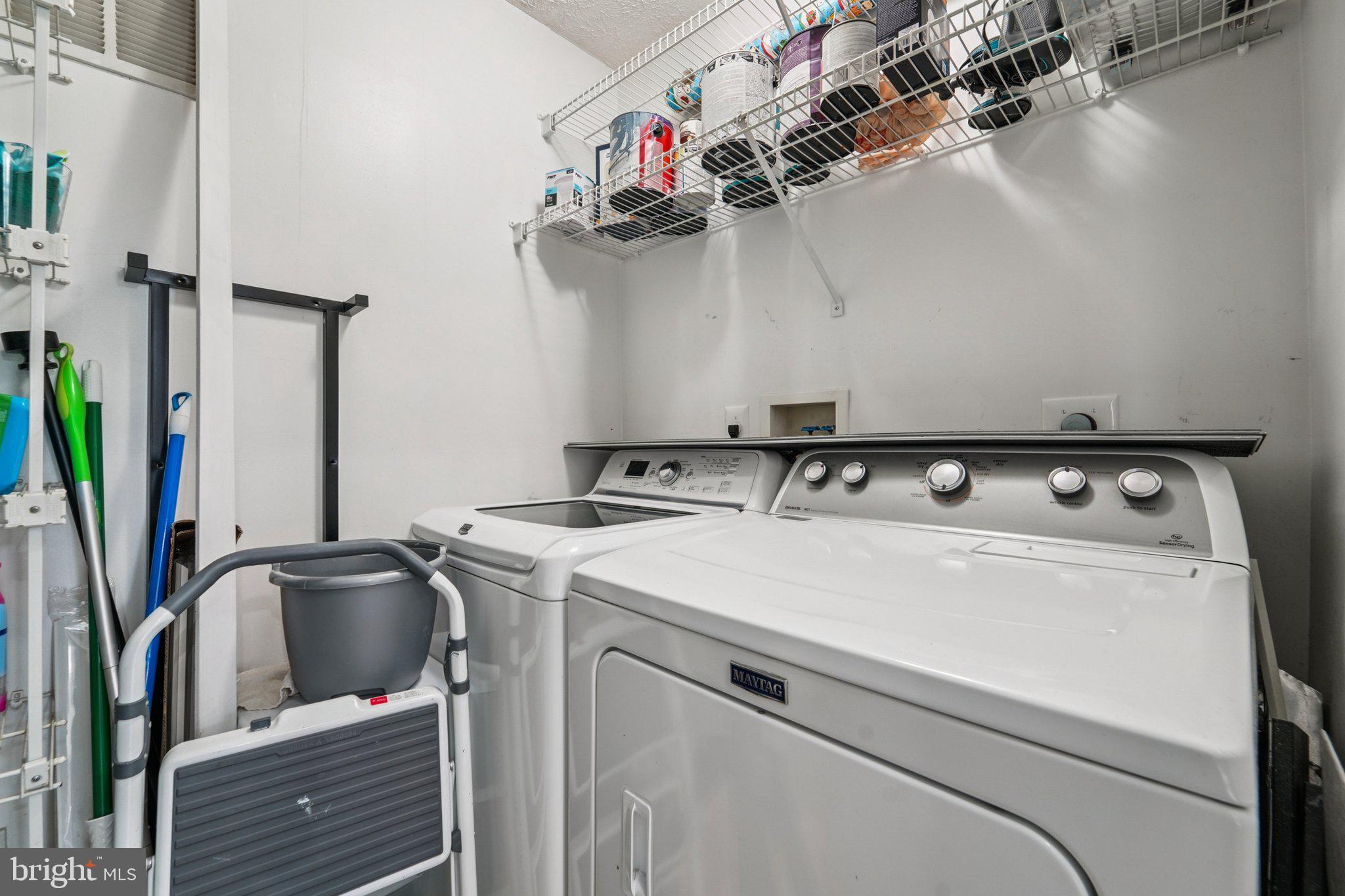 2444 Blue Spring Court, Unit 303 Odenton, MD 21113 - Photo 15 of 24 a utility room with dryer and washer