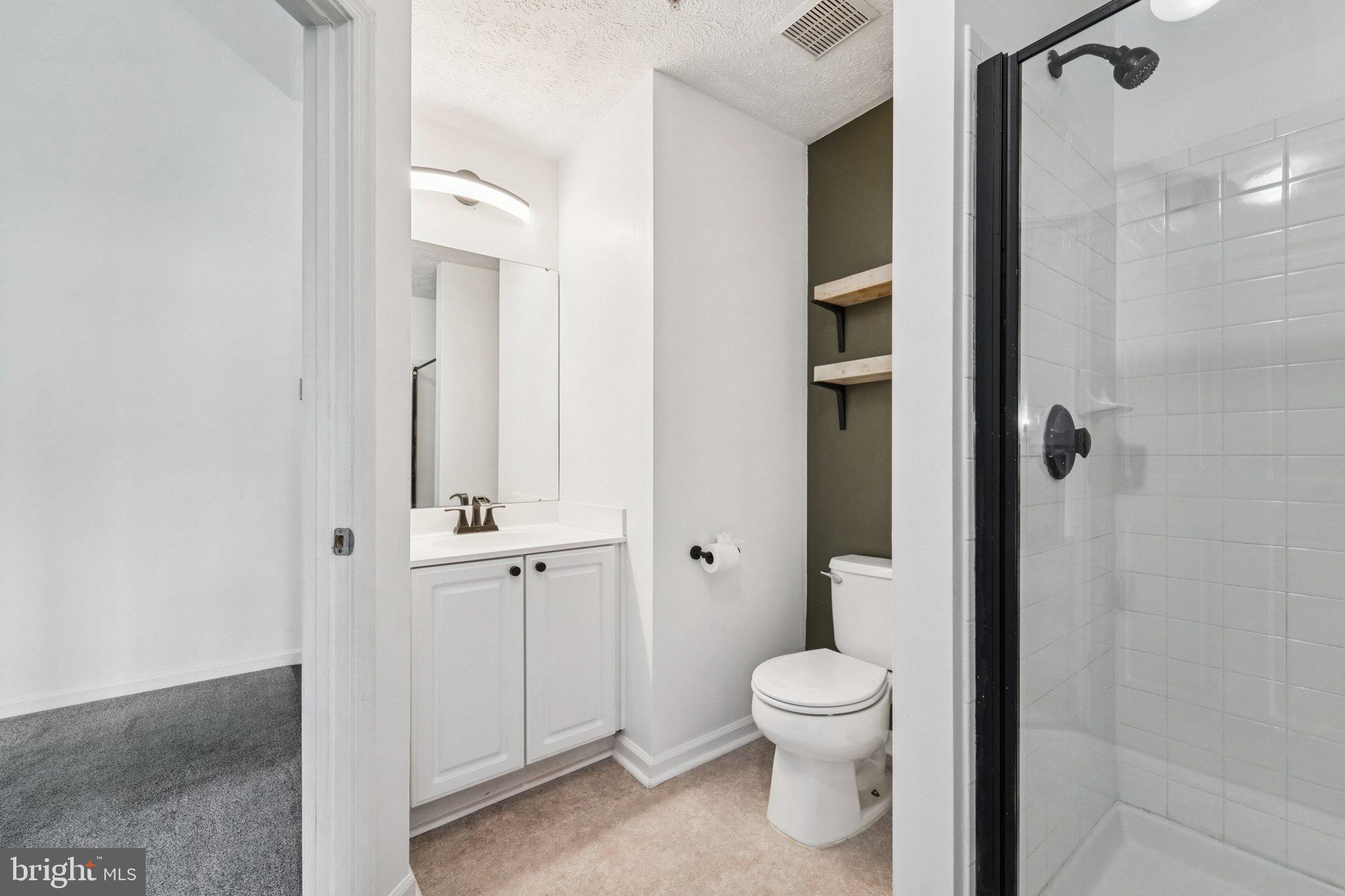 2444 Blue Spring Court, Unit 303 Odenton, MD 21113 - Photo 16 of 24 a bathroom with a toilet a sink and shower