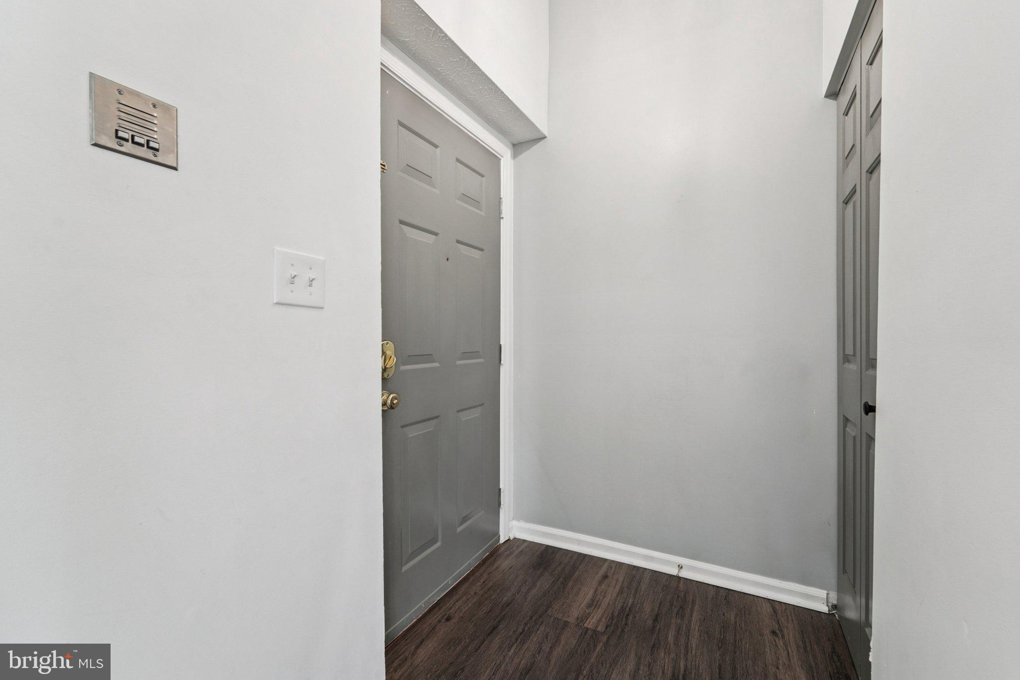 2444 Blue Spring Court, Unit 303 Odenton, MD 21113 - Photo 2 of 24 a view of a hallway with wooden floor