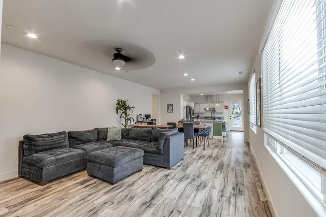 a living room with furniture and wooden floor