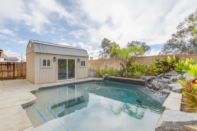 a view of house with swimming pool and outdoor space