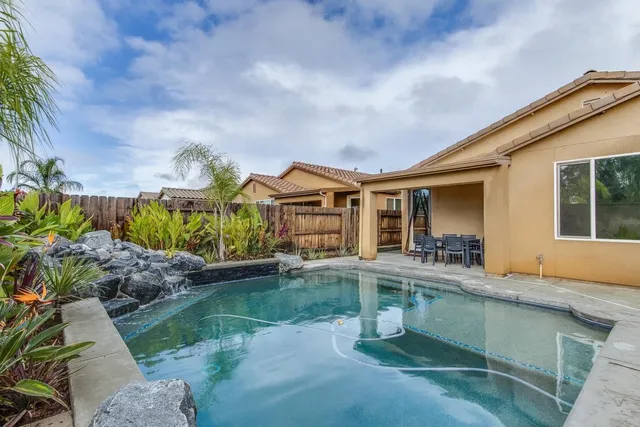 a front view of house and yard with green space