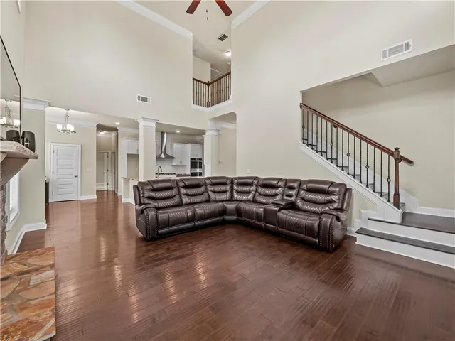 a living room with furniture and wooden floor