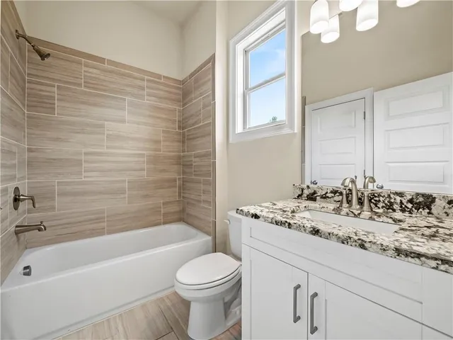 a bathroom with a sink a toilet and bathtub