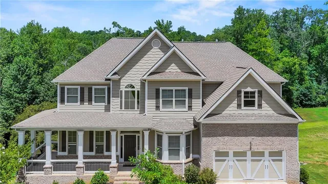 a aerial view of a house with a yard and potted plants