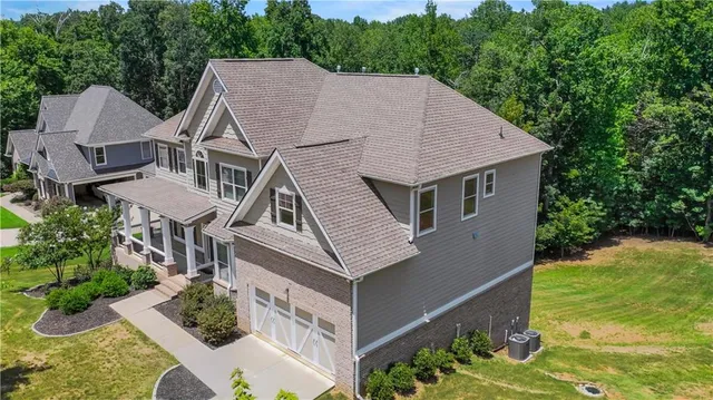 a aerial view of a house with a yard and potted plants
