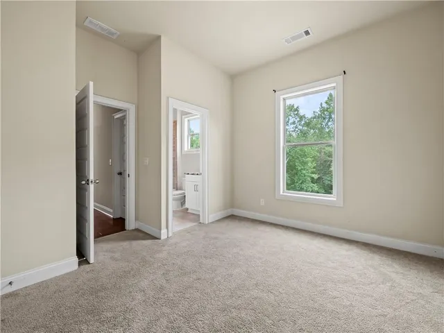 an empty room with windows and closet