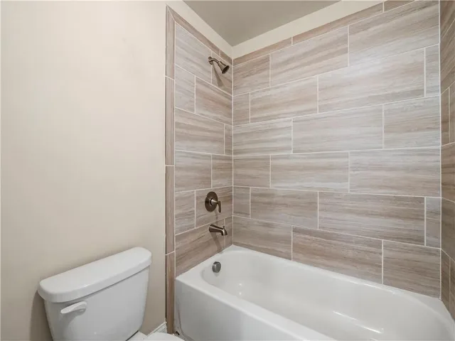 a bathroom with a toilet and a bathtub