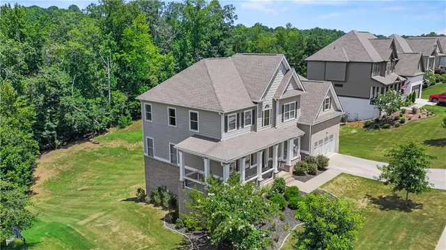 an aerial view of a house with yard porch and furniture