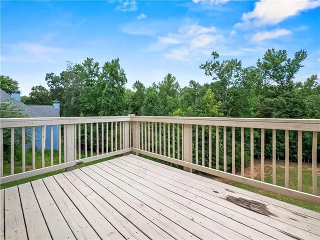 a view of balcony with wooden floor and fence