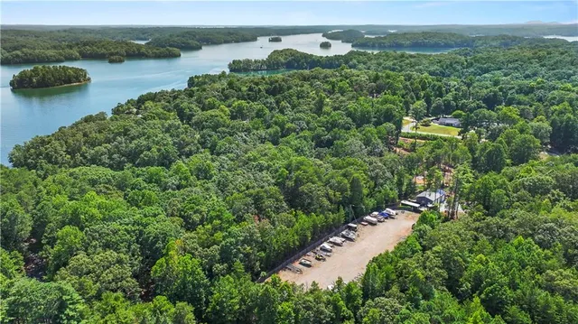 an aerial view of a house with a yard and lake view