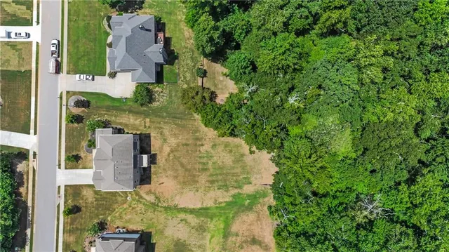 an aerial view of a house with a yard