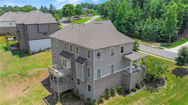 an aerial view of a house with swimming pool garden and patio