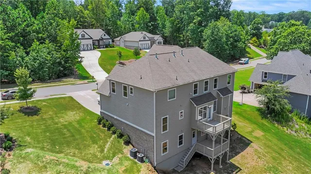 an aerial view of a house with swimming pool garden and patio