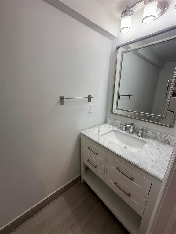 445 Northeast 1st Street Pompano Beach, FL 33060 - Photo 11 of 24 a bathroom with a granite countertop sink a mirror and vanity