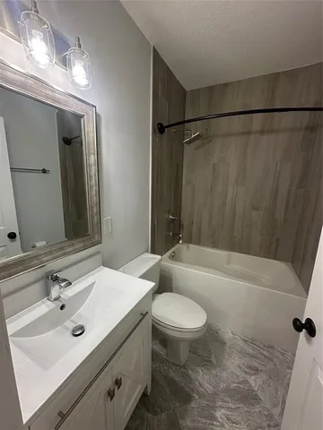 a bathroom with a sink mirror toilet and bathtub