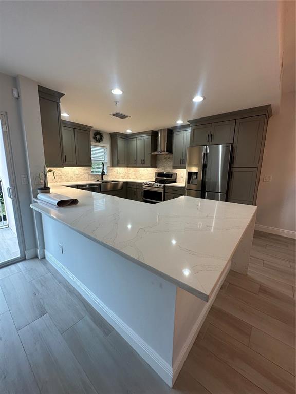 445 Northeast 1st Street Pompano Beach, FL 33060 - Photo 2 of 24 a kitchen with stainless steel appliances a refrigerator sink and microwave