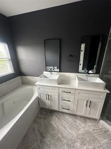 a bathroom with a sink double vanity and mirror