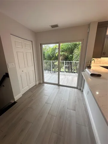 a view of a room with wooden floor and balcony