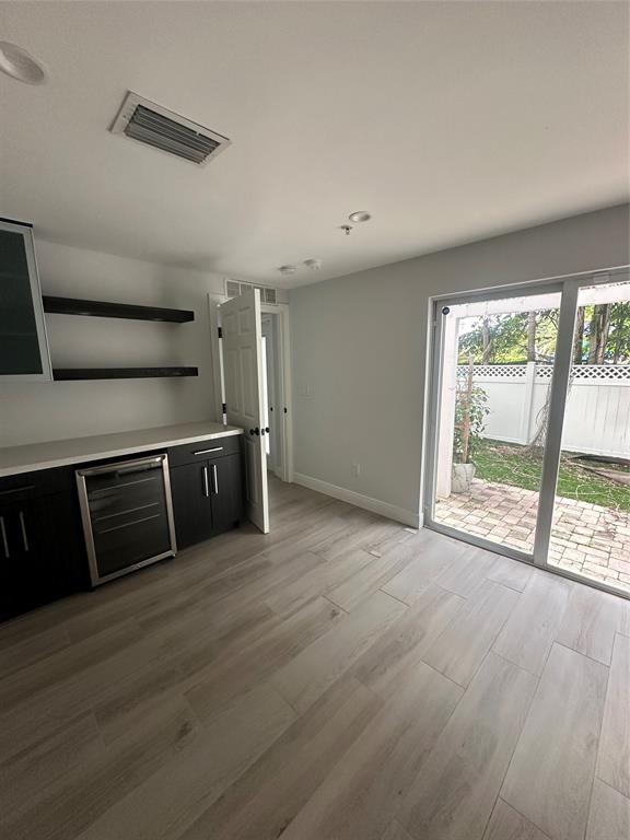 445 Northeast 1st Street Pompano Beach, FL 33060 - Photo 8 of 24 a view of an empty room with wooden floor and a window